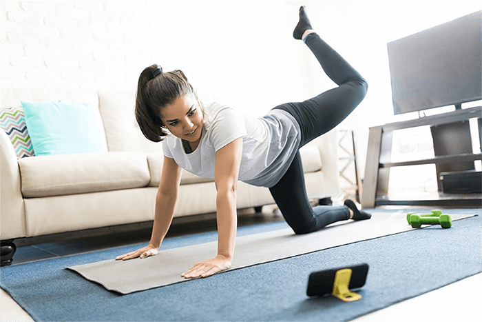 woman doing a light workout in her living room